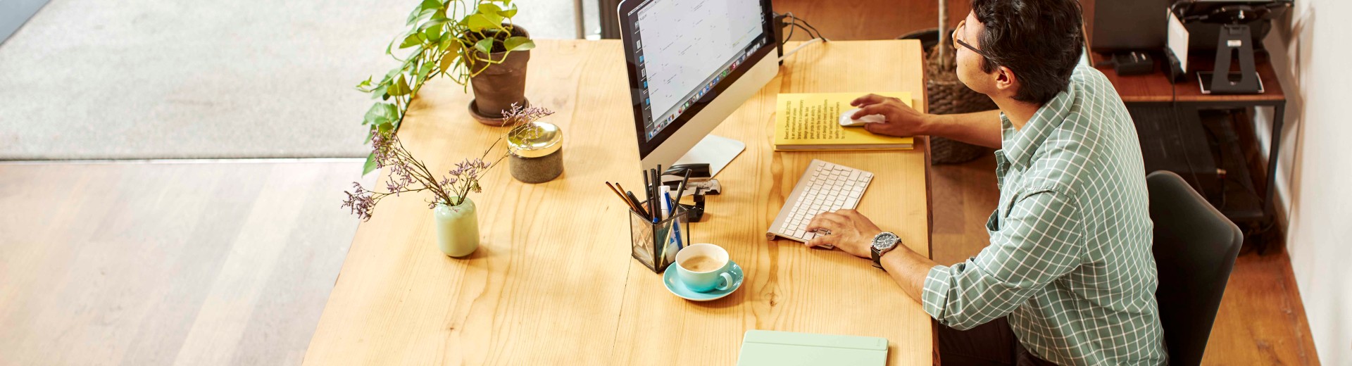 Man working on computer in shop