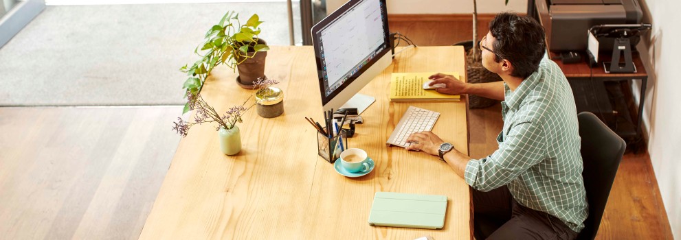 Man working on computer in shop