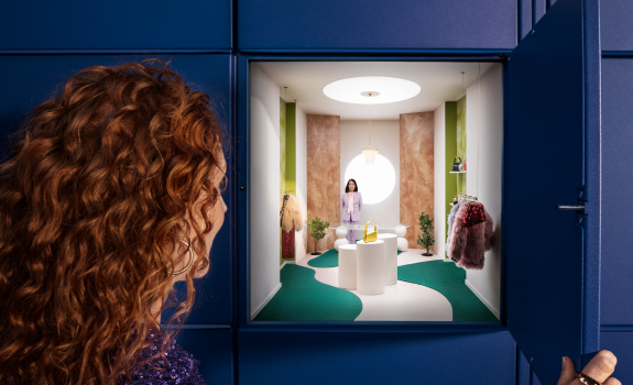 Woman opens a parcel locker, which reveals a view of the store and the online retailer's GLS pick-up points.