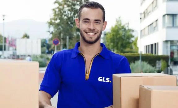 smiling GLS France driver unloading parcel at the back of the truck