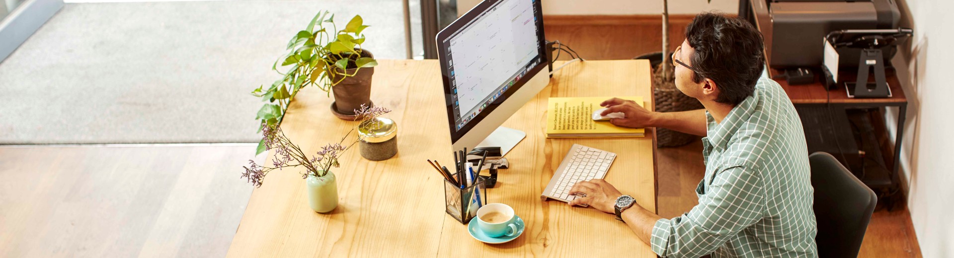 Man working on computer in shop