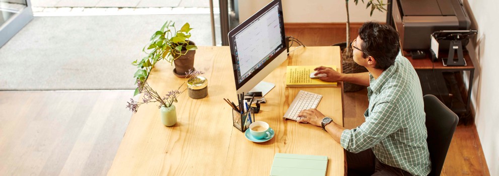 Man working on computer in shop