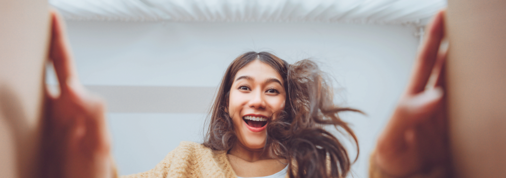 The girl opens a parcel from the courier