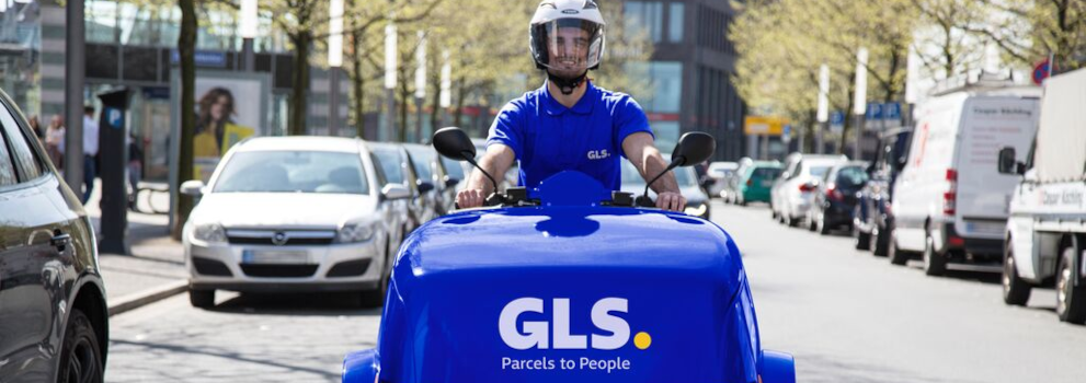 A courier on an e-scooter delivers parcels to customers.