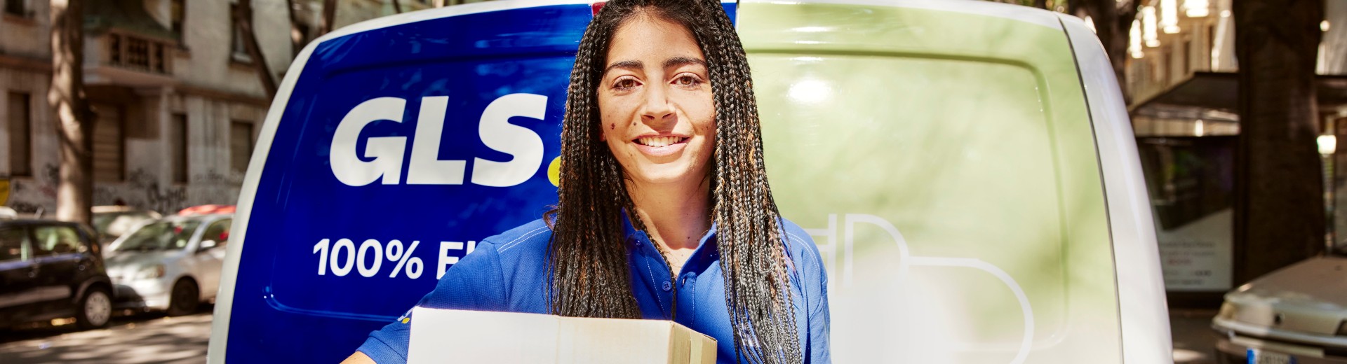 GLS driver woman with a parcel on her arms