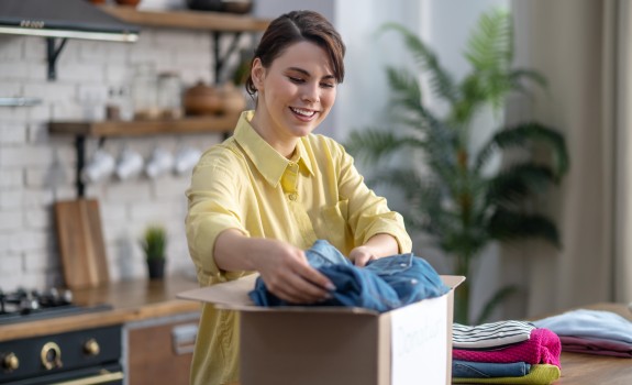 Lady packing clothes into box